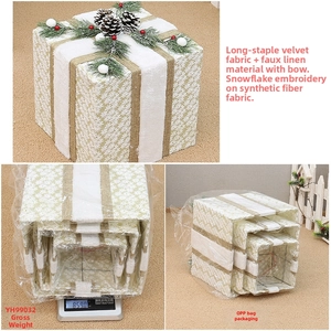 Detail of Christmas gift box set with embroidered snowflakes, pine cones and red berries