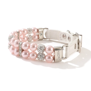Detail of pink pearl pet collar with crystal balls and adjustable leather strap buckle