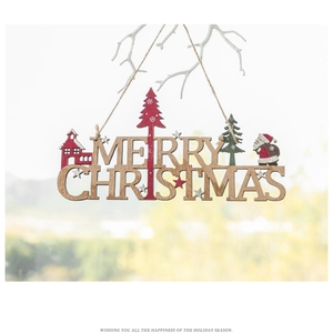 Detail of wooden Merry Christmas hanging ornament with Santa Claus and festive pine trees