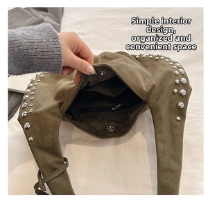 Macro view of suede tote interior showing magnetic clasp, zip pocket and silver rivets