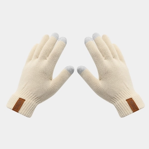 Detail of knitted touchscreen gloves with brown leather logo patch on ribbed cuffs