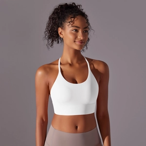 Detail of white halter yoga bra with thin straps and a wide supporting underband