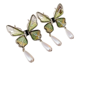 Silver needle butterfly earrings with green wings and water drop pearl pendants