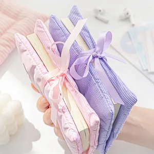 DIY soft striped fabric notebook with ribbon closure in pastel pink and purple tones