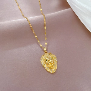 Luxurious gold lion head necklace with sparkling diamonds and green gemstone eyes on silk