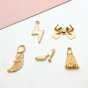 Golden metal charms set including lightning, bow, wing, high heel, and tassel for DIY jewelry