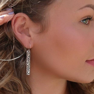 Vintage silver hollow geometric earrings with filigree pattern shown on female model