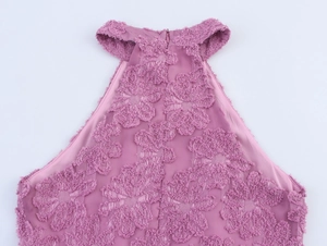 Detail of mauve halter dress showing textured floral flocking fabric and back zipper