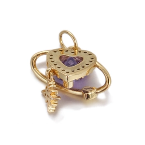 Detailed view of heart-shaped gold pendant with purple stone and small star charm