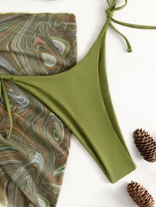 Detailed flat lay of avocado green bikini bottom and marble print mesh sarong set