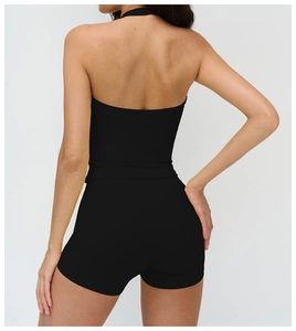 Back view of a black halter yoga top and matching shorts in high-stretch fabric