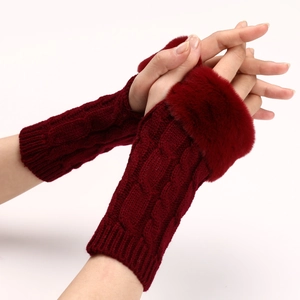 Close-up of burgundy cable knit arm warmers with plush faux fur trim on model