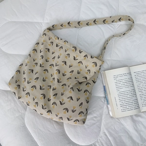 Detail of floral corduroy tote bag showing soft ribbed texture and tulip pattern