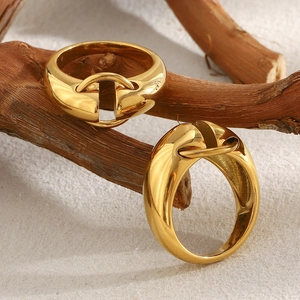 Minimalist 18K gold plated stainless steel geometric ring displayed on natural wood branch