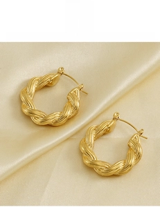 Detail of 18K gold vacuum plated twist hoop earrings on silk with lead-free certification