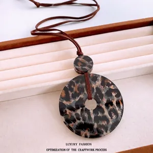 Minimalist round leopard print acrylic pendant necklace with brown faux suede cord
