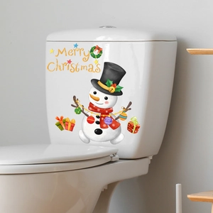 Détail d'un autocollant WC bonhomme de neige avec voeux de Noël sur réservoir céramique