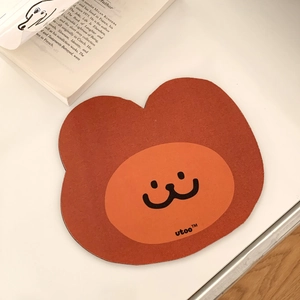 Detail of a brick-red animal shaped mouse pad with premium leather texture on a desk