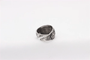 Detail showing vintage silver Viking ring with Thor's hammer and Celtic knot engravings