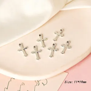 Detailed view of silver cross charms for DIY jewelry making, size 11x19mm set of six