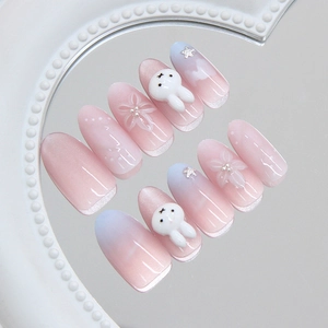 Pink cat eye press-on nails with 3D bunny and floral charms in a 10-piece set