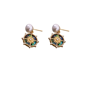 18k gold plated sunburst stud earrings with zircons and pearls on white background