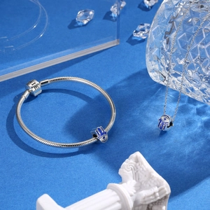 S925 sterling silver Hamsa Hand charm set with blue enamel on a snake chain bracelet