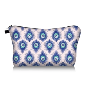 Detail of evil eye pattern makeup bag with durable zipper and peacock feather design