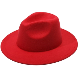 Close-up of a vibrant red wool felt fedora with a wide wavy brim and classic indented crown
