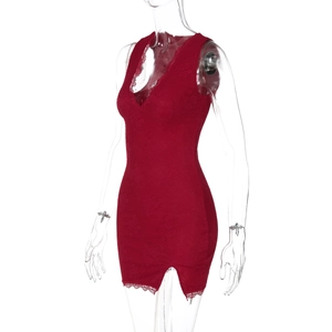 Detail of red lace mini dress showing intricate floral patterns and deep V-neckline