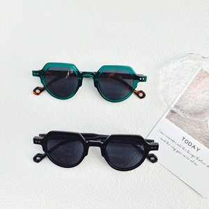 Detailed top view of vintage round sunglasses frames with metal rivets and CE markings