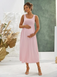Elegant pink sleeveless ribbed knit maternity maxi dress worn by a pregnant model