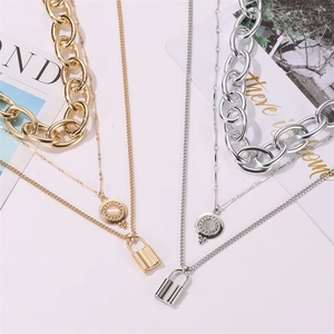 Macro shot of 3-layer punk thick chain necklace with a smooth metal lock pendant
