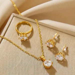 Golden jewelry set featuring round zircon necklace, adjustable ring, and stud earrings