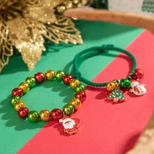 Christmas beaded bracelet set with Santa Claus and Snowman enamel charms on festive background