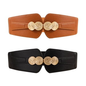 Detail of black and brown elastic waist belts with round embossed golden buckles
