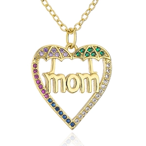 Macro detail of gold heart necklace with MAMA letters and multi-colored gemstones