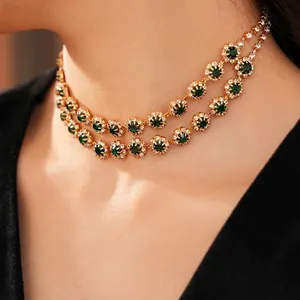 Double-layer gold choker necklace with green round gemstone and sparkling crystals on model