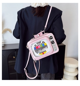 Detailed view of pink retro TV crossbody bag with colorful No Signal screen and heart studs