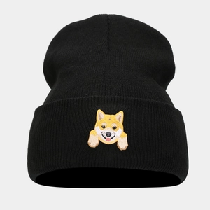 Close-up of cute Shiba Inu embroidery on black knitted cuff beanie for winter fashion