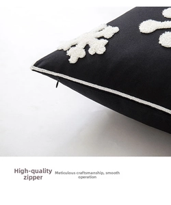Detail of hidden zipper on black pillowcase with white snowflake embroidery