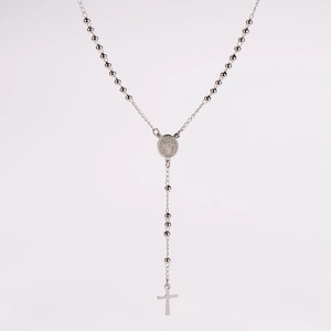 Detailed view of silver stainless steel rosary necklace with cross and medal pendant