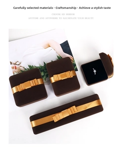 Brown velvet jewelry boxes with gold bows featuring a square ring box and necklace case