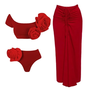 Detailed view of red three-piece swimwear featuring 3D floral accents and a matching long skirt