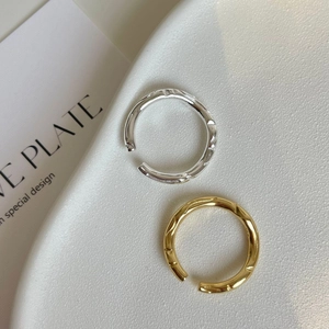 Detailed view of 925 silver irregular twisted knot rings in gold and silver finishes
