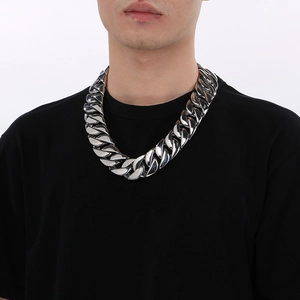Men's 31mm silver Cuban link chain necklace in polished stainless steel on male model