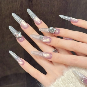 Glittery purple cat-eye gradient press-on nails with large rhinestone and stiletto shape