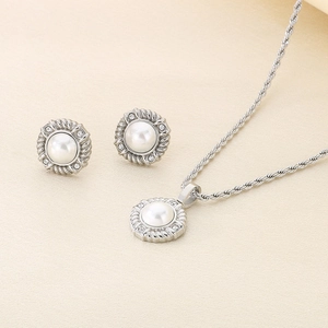 Detailed view of pearl jewelry set with twisted silver borders and zircon accents