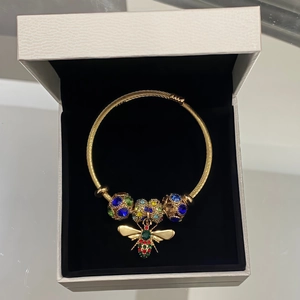 Golden adjustable bee bracelet with sparkling crystal beads in a white jewelry box