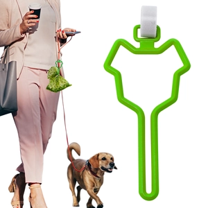 Hands-free dog waste bag holder clip attached to a leash during outdoor walking